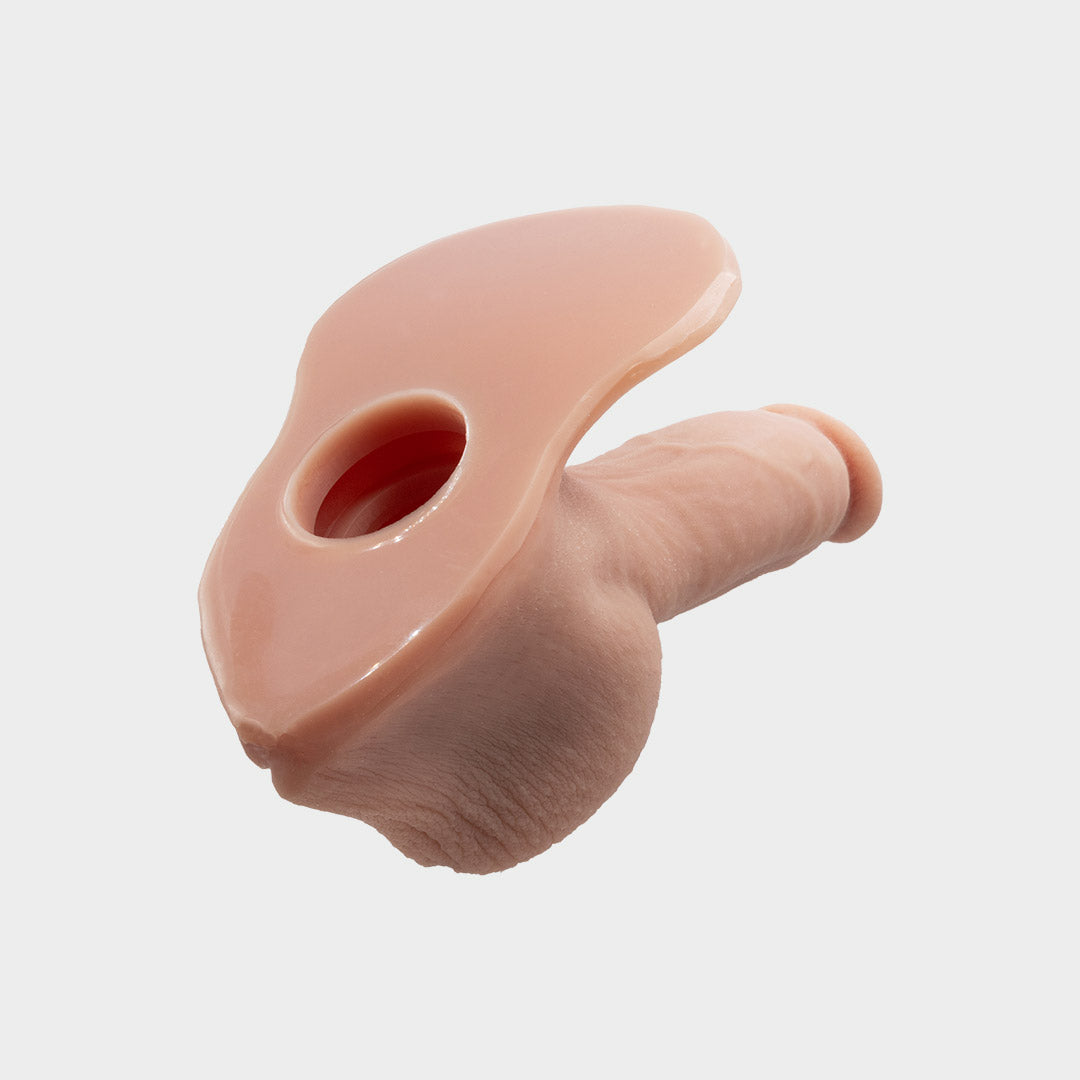 A realistic hard penis play prosthetic with veins and realistic skin features. Brand Banana Prosthetics. Back view with the hole to insert the pleasure plug.