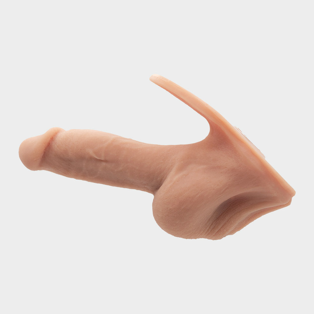 A realistic hard penis play prosthetic with veins and realistic skin features. Brand Banana Prosthetics. Side view.