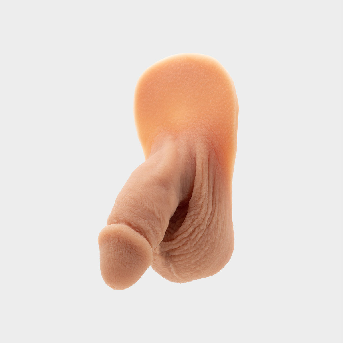 Realistic packer from Banana Prosthetics made of silicone featuring veins, wrinkles, realistic look of a flaccid penis. For trans men, trans masc, nonbinary, ftm people. Front-side-view