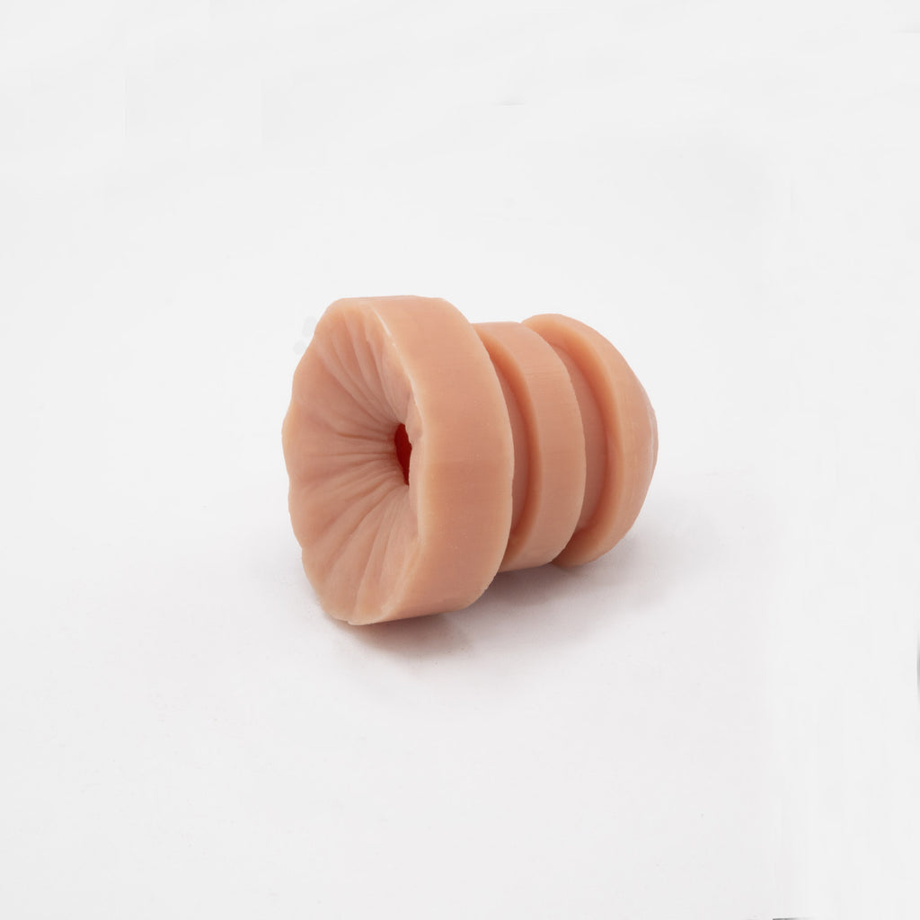 Anus sensation plug of the hard penis packer HP1 banana prosthetics. 7 different skin tones. Side view.