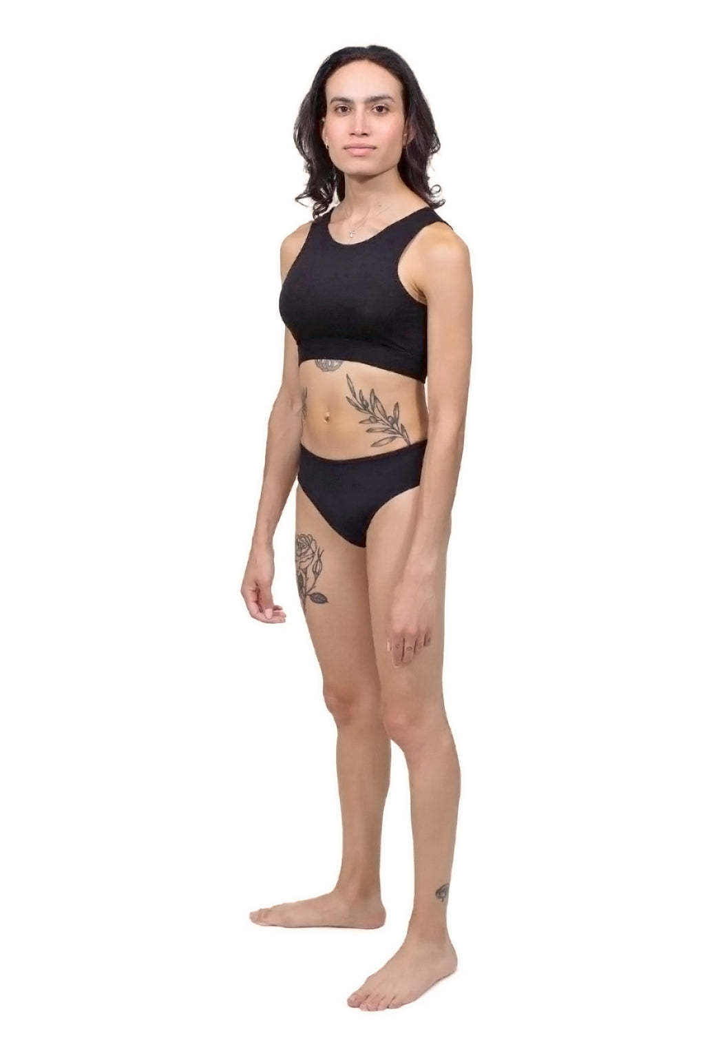 A person wearing a black tucking underwear gaff. Ideal for trans women. trans femme, mtf, nonbinary, drag queens, cosplayers. Side full body view.