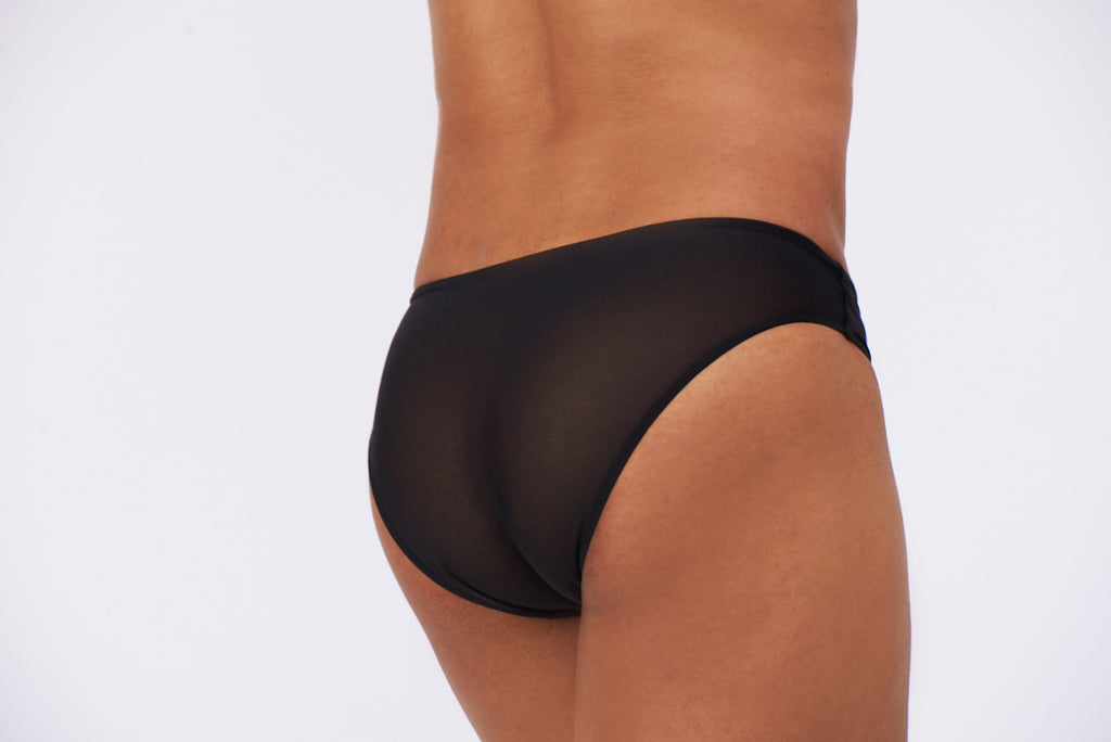 A person wearing a black tucking underwear gaff. Ideal for trans women. trans femme, mtf, nonbinary, drag queens, cosplayers. Back view.