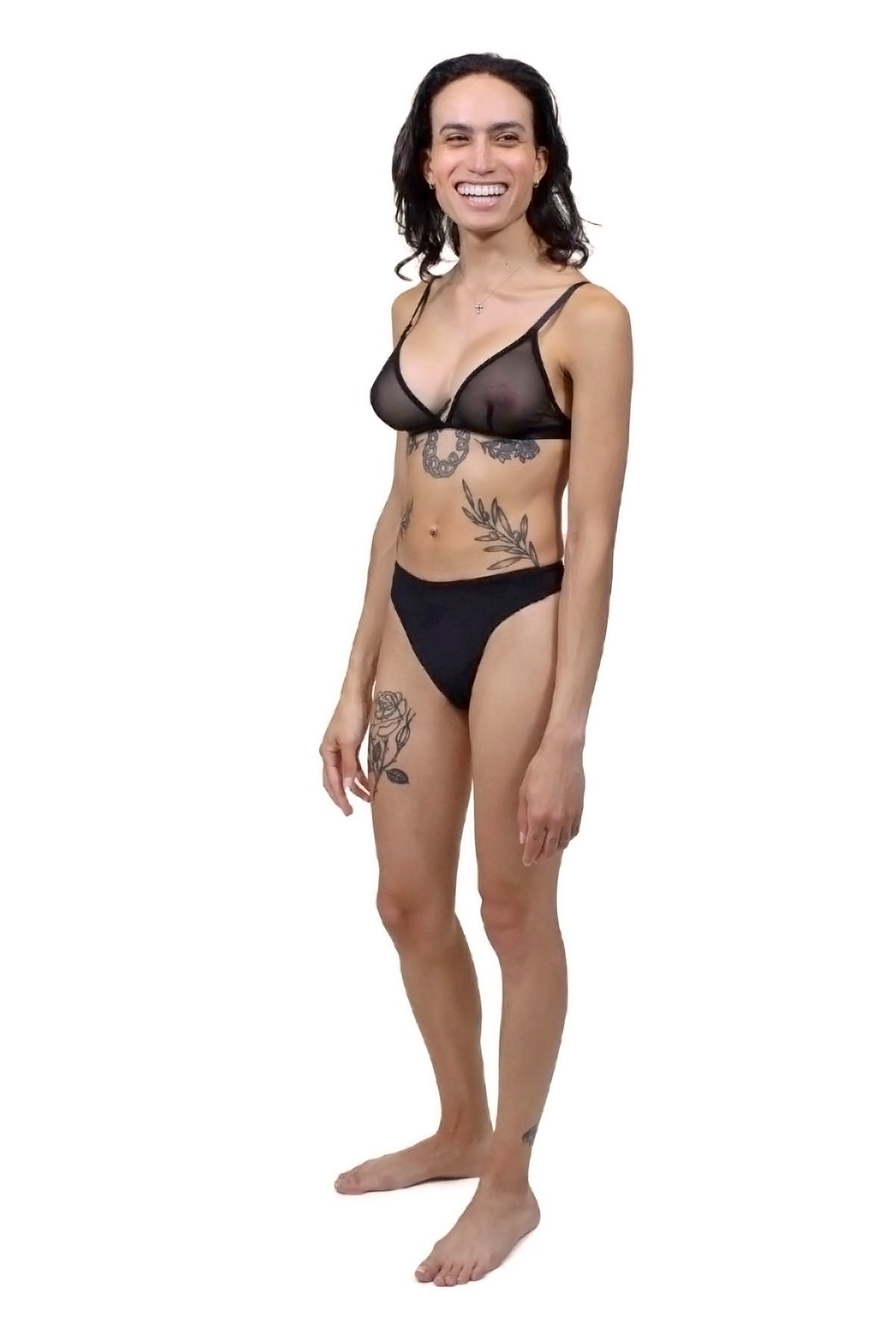 A trans AMAB person wearing tucking underwear. View from the side-front.