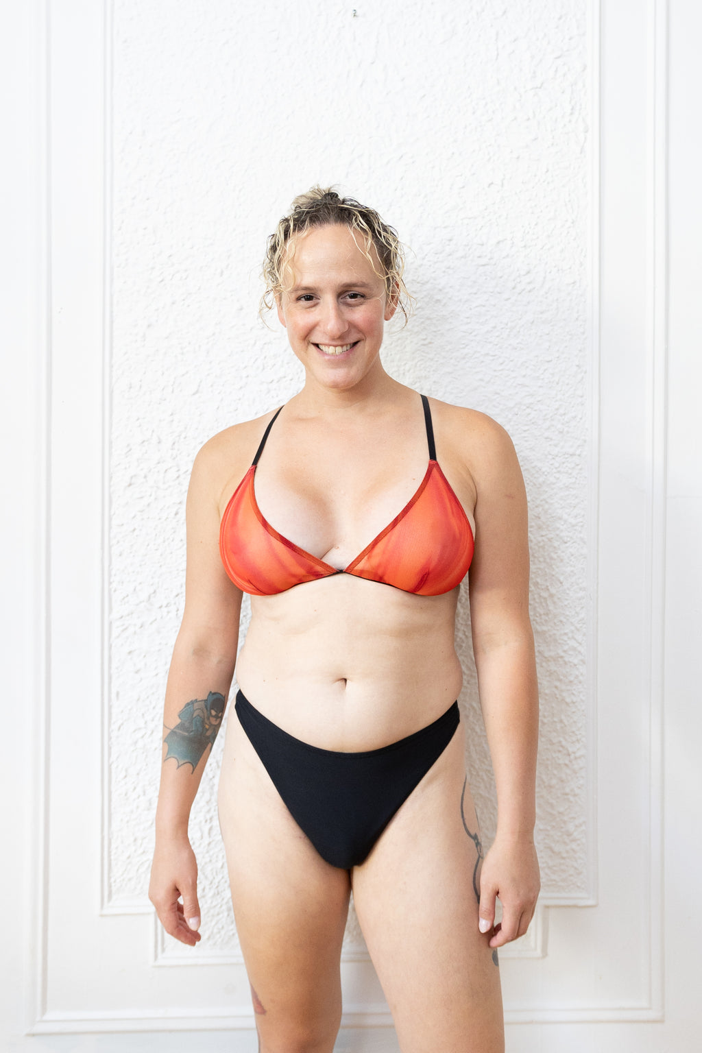 A trans mtf person wearing tucking underwear in black color. View from the front.
